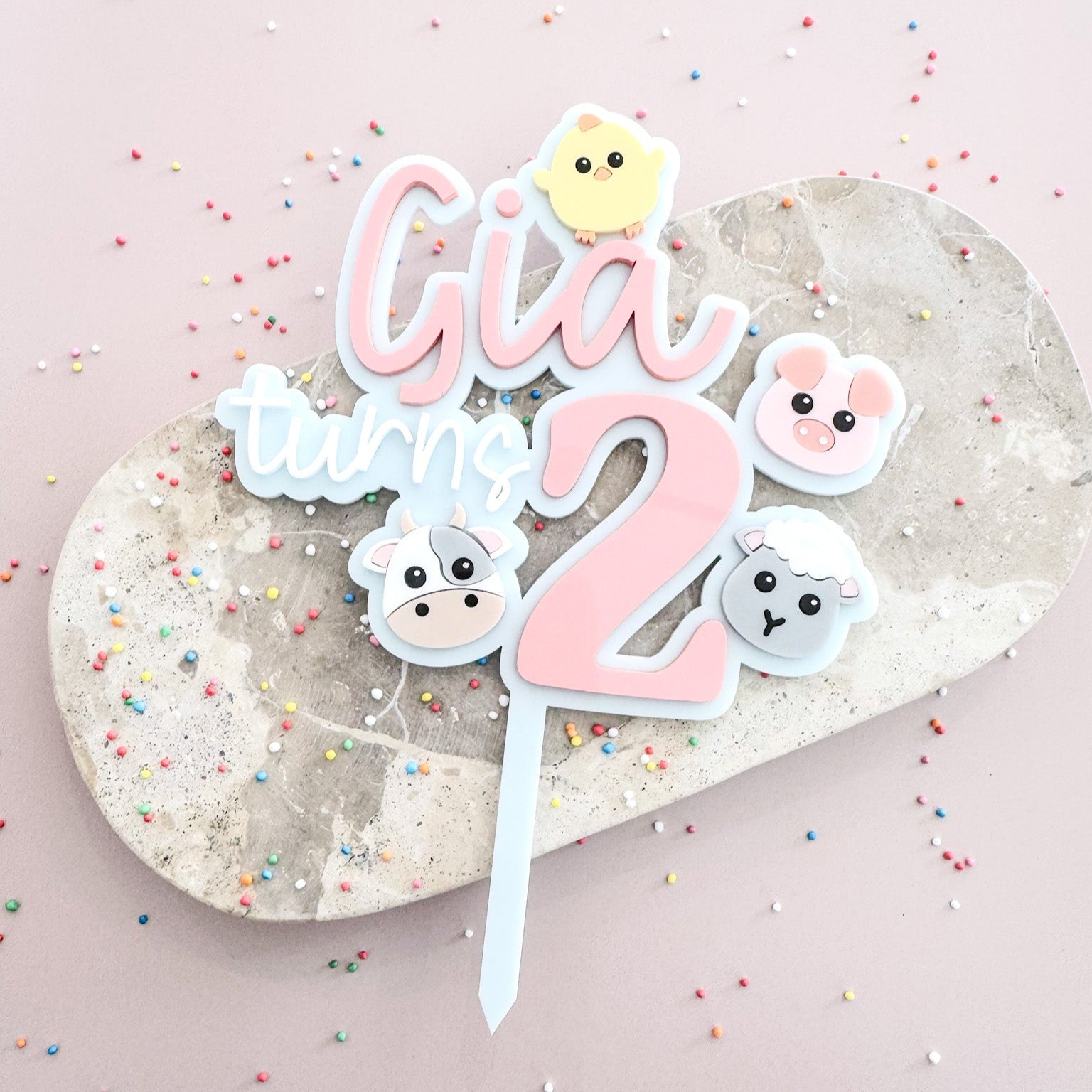 Cake topper for a  2year old featuring farm animals. A chick, a pig, a cow and a sheep.